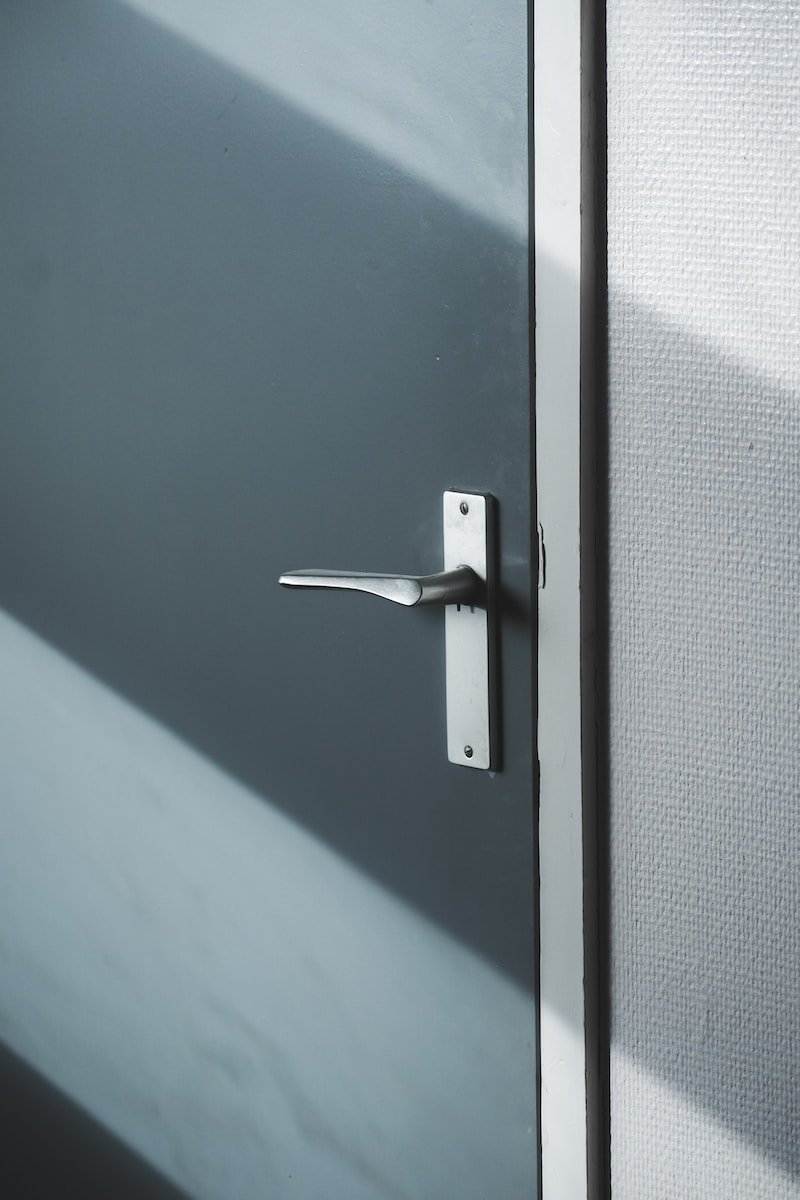 silver door lever on gray door