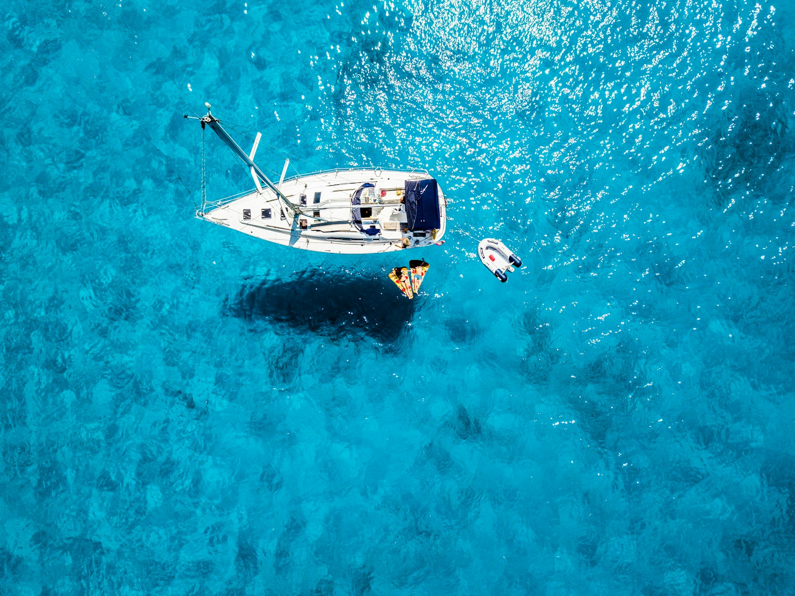 white yacht in middle of blue sea